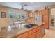 Kitchen island featuring granite countertops, stainless steel appliances, and light wood cabinetry at 8106 Eagle Clan Ct, Las Vegas, NV 89131