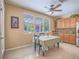 Bright breakfast nook featuring a view of the back yard, adjacent to an open kitchen with wood cabinetry at 8106 Eagle Clan Ct, Las Vegas, NV 89131