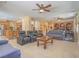 Open concept living room flows seamlessly into kitchen; features tile floors and multiple ceiling fans at 8106 Eagle Clan Ct, Las Vegas, NV 89131