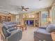 Cozy living room featuring a fireplace, a ceiling fan, and comfortable seating at 8106 Eagle Clan Ct, Las Vegas, NV 89131