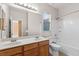 Bathroom featuring double sinks, a tub/shower combo, and bright lighting at 8220 Chimney Bluffs St, North Las Vegas, NV 89085