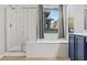 The bathroom features a soaking tub and a large glass shower with tile surround at 8220 Chimney Bluffs St, North Las Vegas, NV 89085