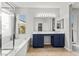 Bright bathroom with a double sink vanity, tub, and natural light at 8220 Chimney Bluffs St, North Las Vegas, NV 89085