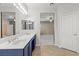 Bathroom featuring dual sinks, tile flooring, and a large mirror at 8220 Chimney Bluffs St, North Las Vegas, NV 89085