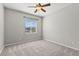Comfortable bedroom with plush carpet, a ceiling fan, and ample natural light at 8220 Chimney Bluffs St, North Las Vegas, NV 89085