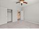 Light filled bedroom featuring a closet, plush carpet and a ceiling fan at 8220 Chimney Bluffs St, North Las Vegas, NV 89085