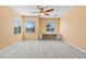 Bright bedroom featuring a built-in desk, ceiling fan, and neutral color palette at 8220 Chimney Bluffs St, North Las Vegas, NV 89085
