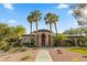 Community clubhouse featuring manicured landscaping, an arched entrance, and prominent signage at 8220 Chimney Bluffs St, North Las Vegas, NV 89085