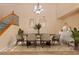 Dining room with hardwood floors, modern chandelier, and seating for six at 8220 Chimney Bluffs St, North Las Vegas, NV 89085