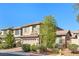 Two-story home featuring a two-car garage and manicured landscaping at 8220 Chimney Bluffs St, North Las Vegas, NV 89085