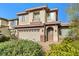 Two-story home featuring a two-car garage and manicured landscaping at 8220 Chimney Bluffs St, North Las Vegas, NV 89085