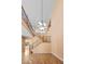 Two story foyer featuring wood-look floors, iron railing staircase, and large chandelier at 8220 Chimney Bluffs St, North Las Vegas, NV 89085