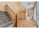 Spacious foyer featuring a staircase with decorative ironwork and an attractive chandelier at 8220 Chimney Bluffs St, North Las Vegas, NV 89085