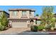 Charming two-story home with a well-manicured lawn, a two-car garage, and inviting curb appeal at 8220 Chimney Bluffs St, North Las Vegas, NV 89085