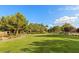 Expansive green space with mature trees, offering a serene and picturesque setting in the community at 8220 Chimney Bluffs St, North Las Vegas, NV 89085