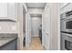 Hallway featuring a laundry area and access to a half bath at 8220 Chimney Bluffs St, North Las Vegas, NV 89085