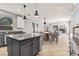 Bright kitchen adjacent to a dining and living space with a granite island at 8220 Chimney Bluffs St, North Las Vegas, NV 89085