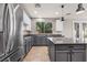 Well-equipped kitchen showcasing a large island, stainless steel appliances, and stylish finishes at 8220 Chimney Bluffs St, North Las Vegas, NV 89085