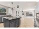 Open-concept kitchen flowing into living area, featuring an island with granite countertop at 8220 Chimney Bluffs St, North Las Vegas, NV 89085