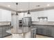 Modern kitchen features stainless steel appliances, a granite island, and ample cabinet space at 8220 Chimney Bluffs St, North Las Vegas, NV 89085