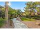 Beautifully landscaped walkway and garden area. Lawn, trees and gravel at 8220 Chimney Bluffs St, North Las Vegas, NV 89085