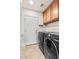 Laundry room with front-loading washer and dryer units and storage cabinets at 8220 Chimney Bluffs St, North Las Vegas, NV 89085
