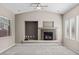Spacious living room featuring a fireplace and ample natural light from large windows at 8220 Chimney Bluffs St, North Las Vegas, NV 89085