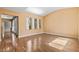 Bright living room featuring glossy wood-look floors and multiple windows for lots of natural light at 8220 Chimney Bluffs St, North Las Vegas, NV 89085