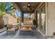 Relaxing covered patio with comfortable seating and outdoor ceiling fan at 8220 Chimney Bluffs St, North Las Vegas, NV 89085