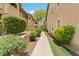 Exterior walkway beside condo featuring well-maintained landscaping at 8985 S Durango Dr # 1177, Las Vegas, NV 89113
