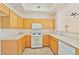 Bright kitchen with white appliances and light wood cabinets at 8985 S Durango Dr # 1177, Las Vegas, NV 89113
