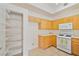 Kitchen featuring white appliances, light wood cabinets, and large pantry at 8985 S Durango Dr # 1177, Las Vegas, NV 89113