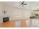 Spacious living room featuring hardwood floors, a fireplace, and an exterior balcony at 8985 S Durango Dr # 1177, Las Vegas, NV 89113