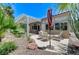 Inviting back patio with lounge chairs, pergola cover, and lush landscaping at 9220 Evergreen Canyon Dr, Las Vegas, NV 89134