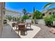 Spacious backyard with patio area, lush greenery, and mature trees at 9220 Evergreen Canyon Dr, Las Vegas, NV 89134