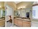 This bathroom features double sinks with granite countertops and a view into the primary bedroom and walk-in closet at 9220 Evergreen Canyon Dr, Las Vegas, NV 89134