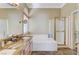 Bright bathroom featuring double sinks, granite countertops, separate shower, and a luxurious soaking tub at 9220 Evergreen Canyon Dr, Las Vegas, NV 89134
