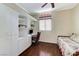 Cozy bedroom featuring built-in desk, shelves, and hardwood floors at 9220 Evergreen Canyon Dr, Las Vegas, NV 89134