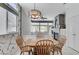 Cozy dining area features a fireplace, wainscoting, view of the backyard, and a modern chandelier at 9220 Evergreen Canyon Dr, Las Vegas, NV 89134