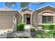 Beautiful home featuring a well-manicured lawn, front shrubs, and a covered entryway at 9220 Evergreen Canyon Dr, Las Vegas, NV 89134
