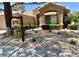 Inviting single-story home showcasing a well-manicured front yard and a cozy exterior at 9220 Evergreen Canyon Dr, Las Vegas, NV 89134