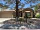Charming single-story home featuring a landscaped front yard and a neutral-toned exterior at 9220 Evergreen Canyon Dr, Las Vegas, NV 89134