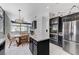 Bright kitchen with stainless steel appliances, marble countertops, dining area, and adjacent living area at 9220 Evergreen Canyon Dr, Las Vegas, NV 89134