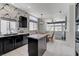 Open kitchen featuring stainless steel appliances, an island, adjacent dining area, and patterned wallpaper at 9220 Evergreen Canyon Dr, Las Vegas, NV 89134