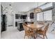 Bright kitchen with tile floors, black cabinetry, dining table, and black-and-white patterned wallpaper at 9220 Evergreen Canyon Dr, Las Vegas, NV 89134