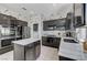 Stylish kitchen with stainless steel appliances, marble countertops, an island, and unique wallpaper at 9220 Evergreen Canyon Dr, Las Vegas, NV 89134