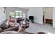 Spacious living room featuring vaulted ceilings, carpet, leather seating, and abundant natural light at 9220 Evergreen Canyon Dr, Las Vegas, NV 89134