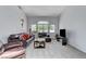 Bright living room with carpet, leather seating, and windows at 9220 Evergreen Canyon Dr, Las Vegas, NV 89134