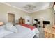 Spacious bedroom with a ceiling fan, carpet floors, a desk, and a view of the en suite bathroom at 9220 Evergreen Canyon Dr, Las Vegas, NV 89134