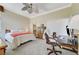 Comfortable bedroom with a ceiling fan, crown moulding, carpet floors, and dedicated office space at 9220 Evergreen Canyon Dr, Las Vegas, NV 89134